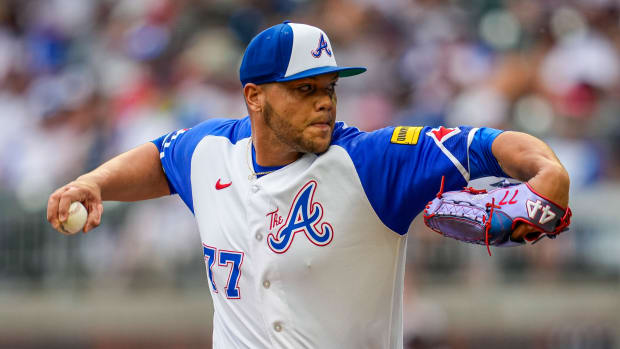 Jul 1, 2023; Cumberland, Georgia, USA; Atlanta Braves relief pitcher Joe Jimenez (77) pitches against the Miami Marlins during the ninth inning at Truist Park. Mandatory Credit: Dale Zanine-USA TODAY Sports